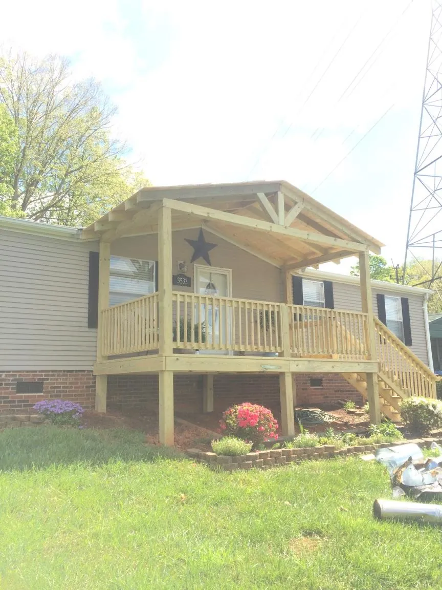 New gabled porch roof and deck railing added to a ranch home in Decatur